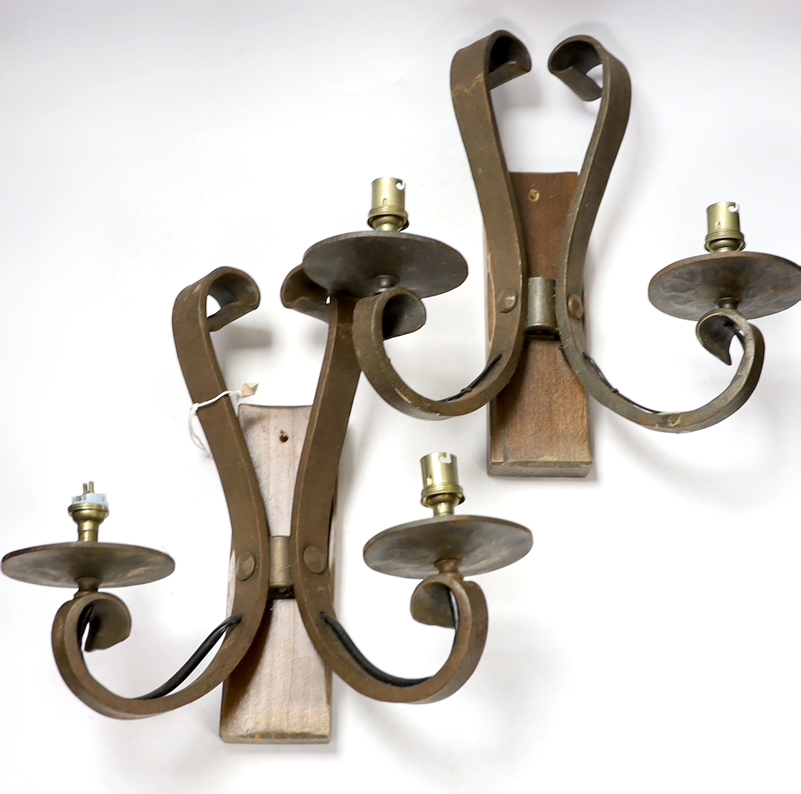 A pair of wrought iron two branch wall lights, height 33cm